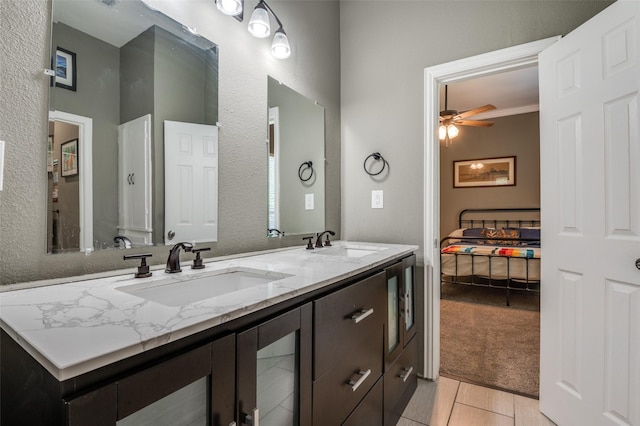 411 E Ross St, Waxahachie, TX 75165 - bathroom with ceiling fan, double vanity, a textured wall, and tile patterned flooring