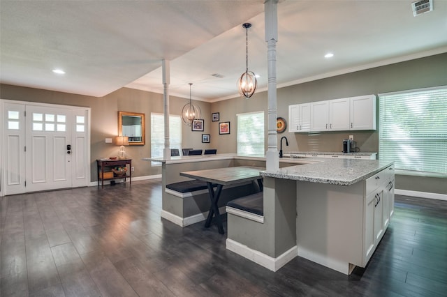 411 E Ross St, Waxahachie, TX 75165 - kitchen with baseboards, recessed lighting, white cabinetry, light stone countertops, and decorative light fixtures