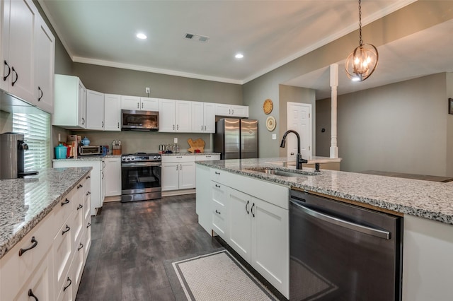 411 E Ross St, Waxahachie, TX 75165 - kitchen featuring appliances with stainless steel finishes, a sink, ornamental molding, white cabinets, and light stone countertops