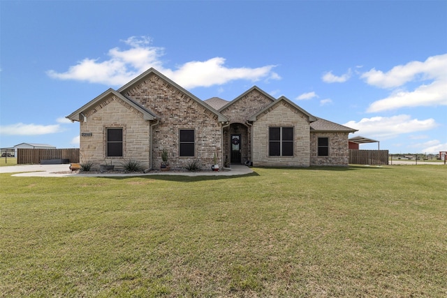 2210 County Road 1104, Cleburne, TX 76031 - french provincial home featuring fence, brick siding, and a front yard