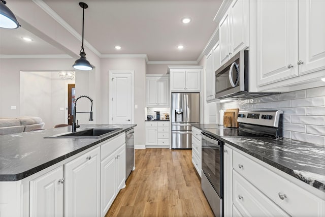 2210 County Road 1104, Cleburne, TX 76031 - kitchen with stainless steel appliances, a sink, recessed lighting, white cabinetry, and decorative backsplash