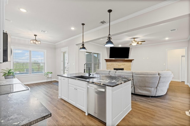 2210 County Road 1104, Cleburne, TX 76031 - kitchen featuring a sink, light wood-type flooring, stainless steel appliances, a fireplace, and visible vents