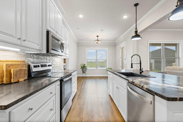 2210 County Road 1104, Cleburne, TX 76031 - kitchen with dark countertops, a sink, baseboards, appliances with stainless steel finishes, and white cabinetry