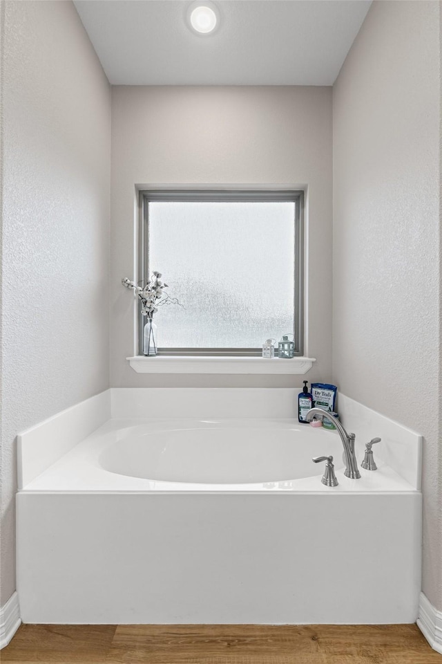 2210 County Road 1104, Cleburne, TX 76031 - bathroom with plenty of natural light, a garden tub, and wood finished floors