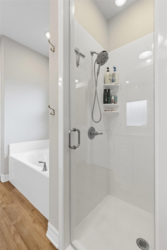 2210 County Road 1104, Cleburne, TX 76031 - full bathroom with a garden tub, wood finished floors, and a shower stall