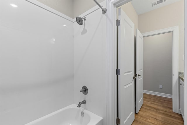 2210 County Road 1104, Cleburne, TX 76031 - bathroom with wood finished floors, baseboards, shower / bathtub combination, and visible vents