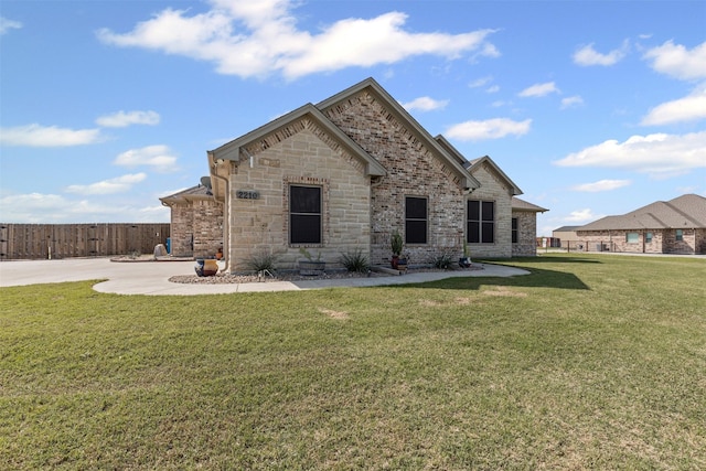 2210 County Road 1104, Cleburne, TX 76031 - view of front of property featuring stone siding, a front lawn, and fence