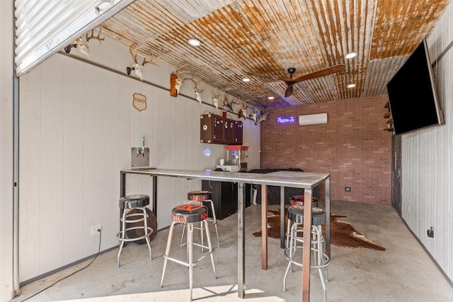 2210 County Road 1104, Cleburne, TX 76031 - kitchen featuring concrete floors, a wall unit AC, and ceiling fan