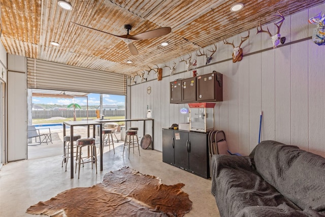 2210 County Road 1104, Cleburne, TX 76031 - interior space with wood ceiling, a ceiling fan, wooden walls, and concrete floors