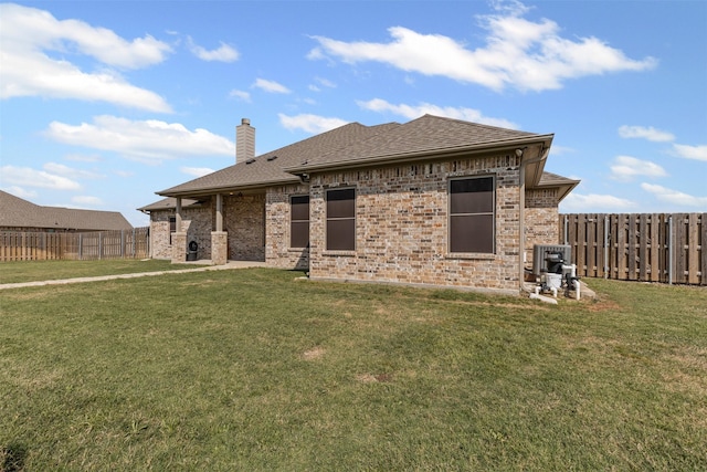 2210 County Road 1104, Cleburne, TX 76031 - back of property featuring a lawn, roof with shingles, a chimney, and a fenced backyard