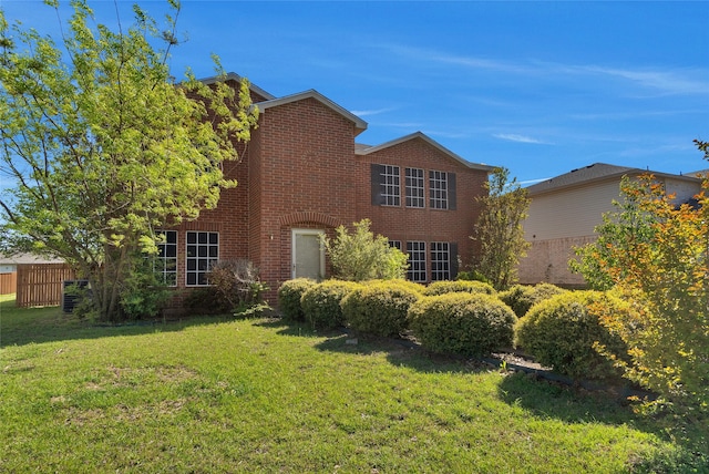 view of front of home featuring brick siding and a front lawn