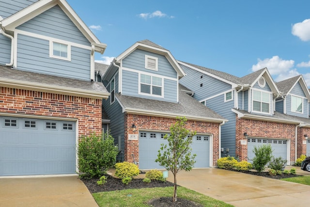 view of front of home with concrete driveway, a garage, and brick siding