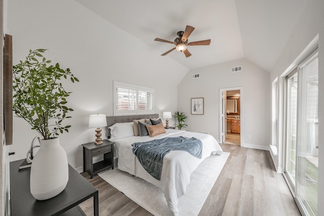 bedroom with vaulted ceiling, ensuite bathroom, visible vents, and light wood-type flooring