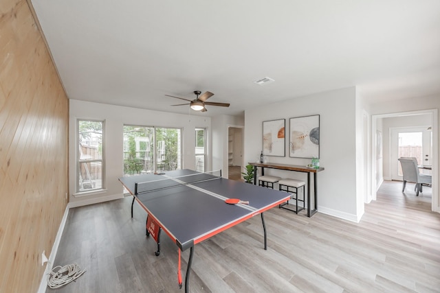 playroom with baseboards, a healthy amount of sunlight, visible vents, and light wood-style flooring