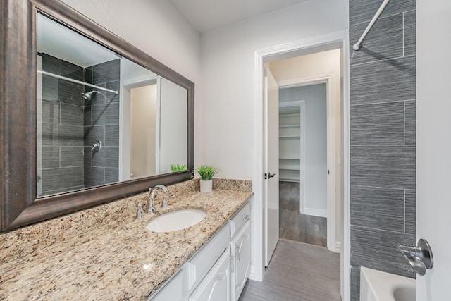 full bath with baseboards and vanity