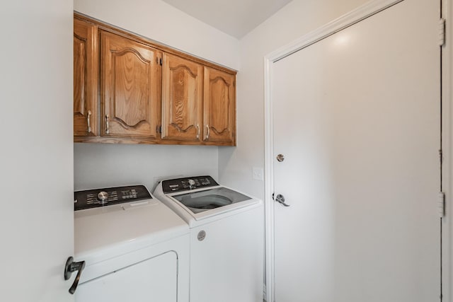 laundry area with cabinet space and independent washer and dryer