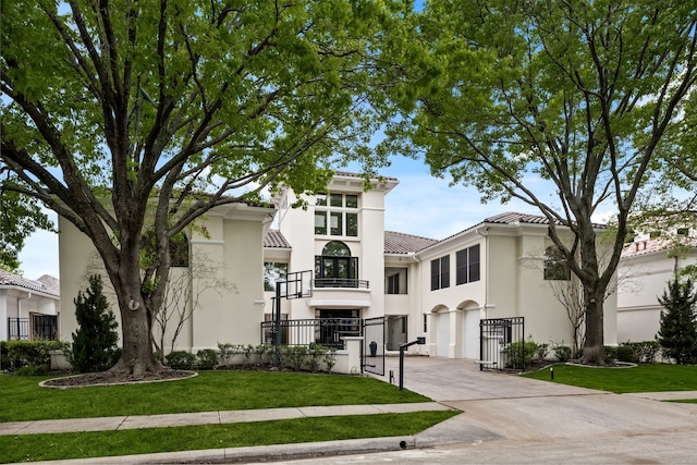5608 Stone Cliff Ct, Dallas, TX 75287 - view of front of house featuring a front lawn, a balcony, stucco siding, concrete driveway, and a tile roof