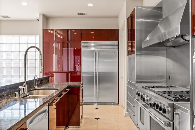 5608 Stone Cliff Ct, Dallas, TX 75287 - kitchen featuring wall chimney exhaust hood, a sink, visible vents, high quality appliances, and light tile patterned floors