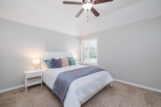 carpeted bedroom with vaulted ceiling, baseboards, and ceiling fan