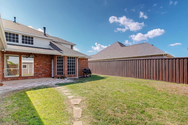 view of yard with a patio area and a fenced backyard