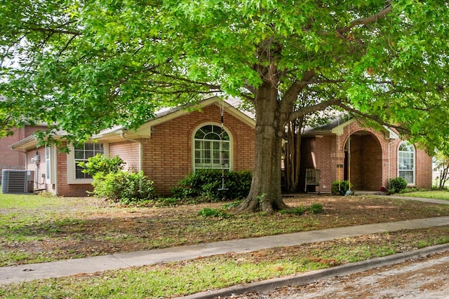 ranch-style home with brick siding and central AC unit