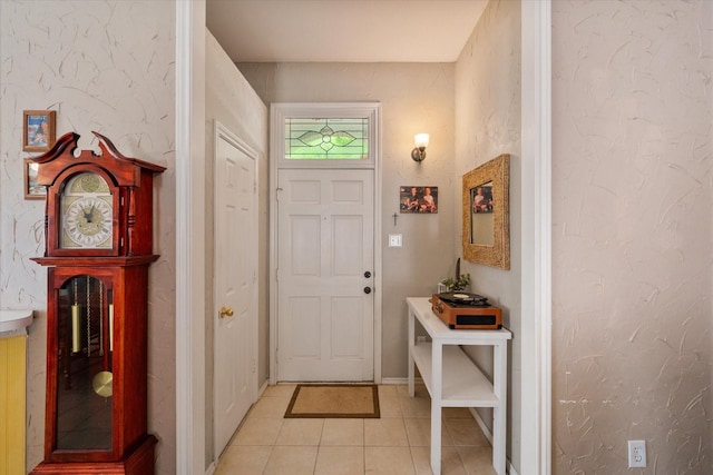 foyer entrance with baseboards and light tile patterned floors