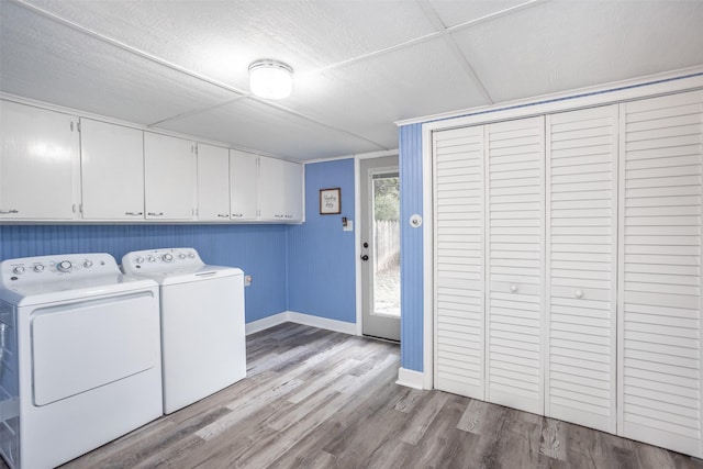 308 N Pecan St, Muenster, TX 76252 - laundry room featuring baseboards, cabinet space, wood finished floors, and washer and clothes dryer
