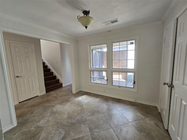 interior space featuring ornamental molding, baseboards, visible vents, and stairway