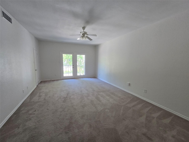 spare room featuring ceiling fan, baseboards, carpet flooring, and visible vents