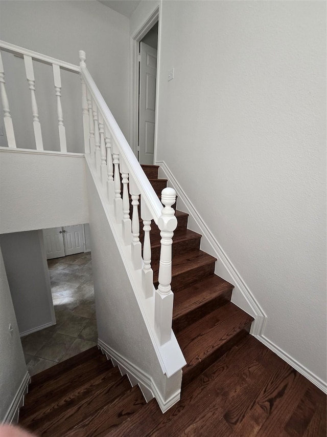 stairs featuring wood finished floors