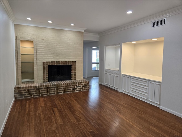 unfurnished living room featuring baseboards, ornamental molding, dark wood-type flooring, and visible vents