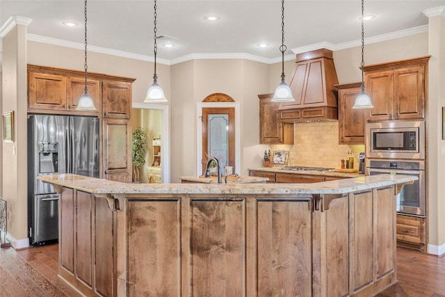 kitchen featuring stainless steel appliances, brown cabinetry, custom range hood, and dark wood-style flooring