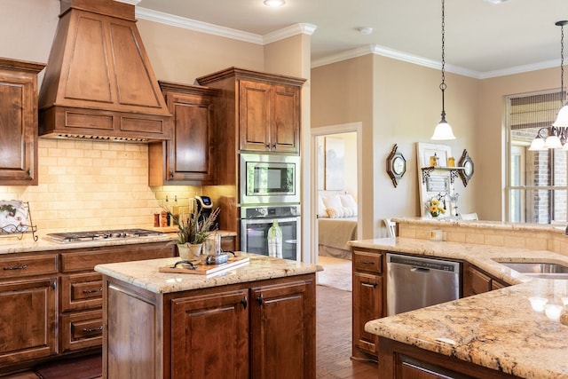 kitchen with custom exhaust hood, light stone counters, a sink, ornamental molding, and appliances with stainless steel finishes