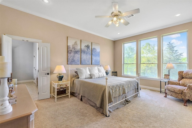 bedroom with visible vents, crown molding, baseboards, light colored carpet, and ceiling fan