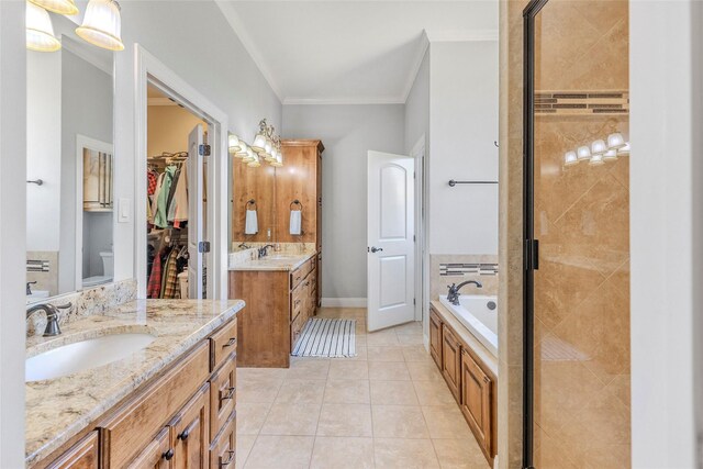 bathroom with a shower stall, tile patterned flooring, ornamental molding, a sink, and a bath