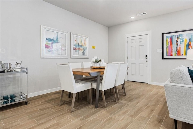 dining space with visible vents, light wood-style flooring, baseboards, and recessed lighting