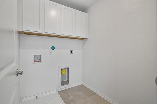 laundry area featuring electric dryer hookup, cabinet space, washer hookup, and baseboards
