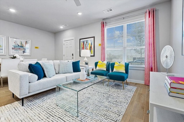 living room featuring baseboards, visible vents, recessed lighting, ceiling fan, and wood finish floors