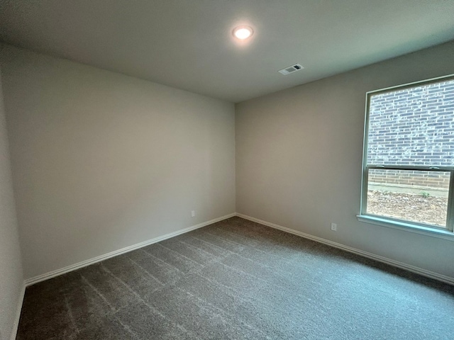 3515 Columbus St, Gainesville, TX 76240 - empty room featuring baseboards and dark colored carpet