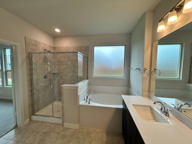 3515 Columbus St, Gainesville, TX 76240 - bathroom with vanity, a bath, plenty of natural light, and a shower stall