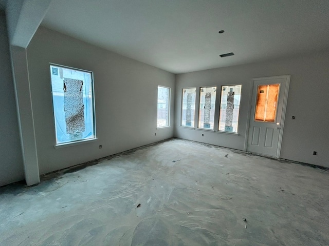 unfurnished living room with visible vents
