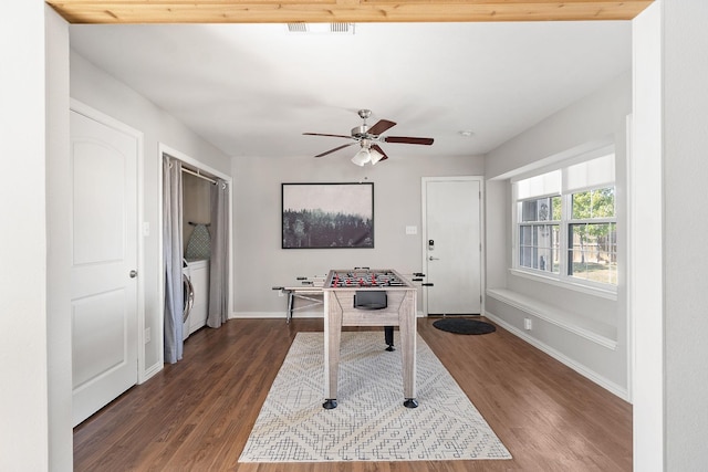 office area with baseboards, visible vents, ceiling fan, dark wood-type flooring, and washer / dryer