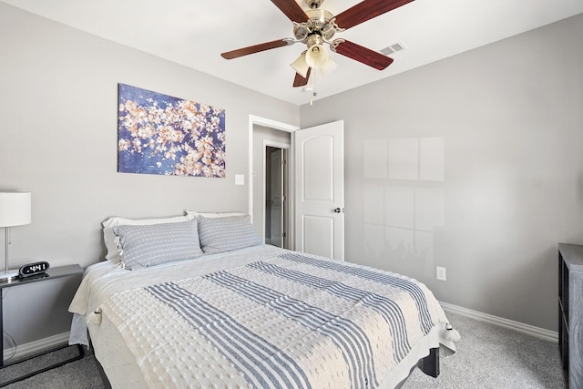carpeted bedroom featuring visible vents, a ceiling fan, and baseboards