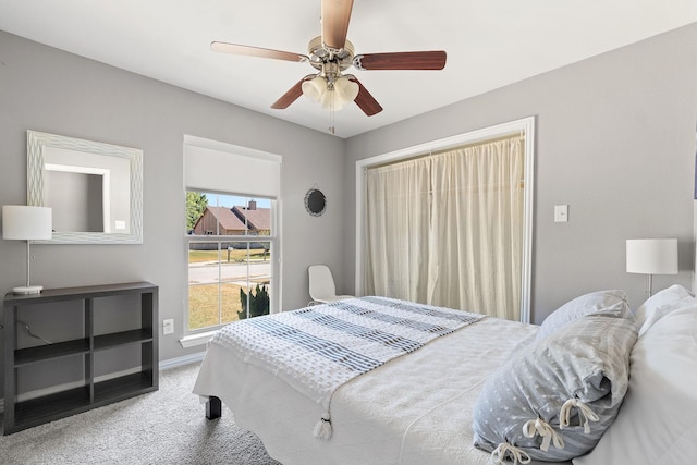 carpeted bedroom featuring a ceiling fan and baseboards