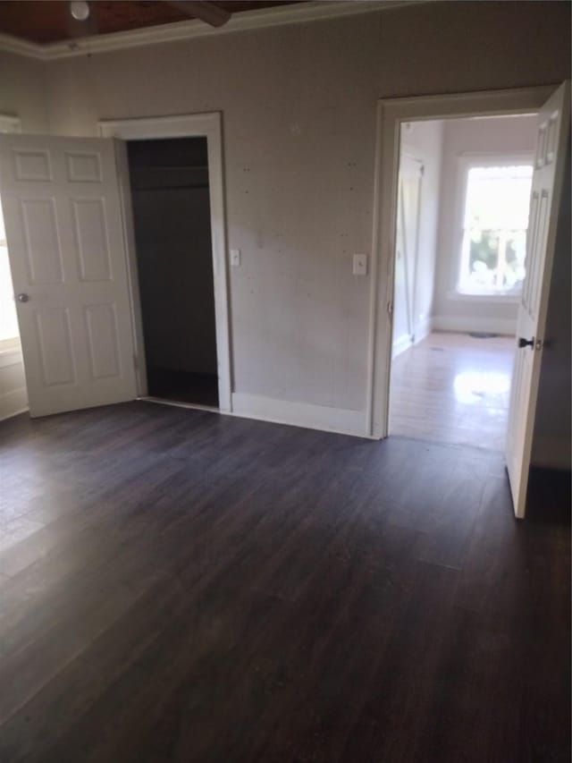 511 Chandler St, Minden, LA 71055 - unfurnished bedroom with baseboards, dark wood finished floors, and crown molding