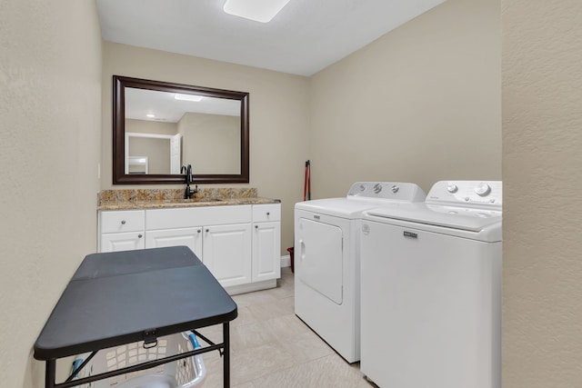 327 Saddle Club Rd, Weatherford, TX 76088 - laundry room with cabinet space, a textured wall, washing machine and clothes dryer, and a sink