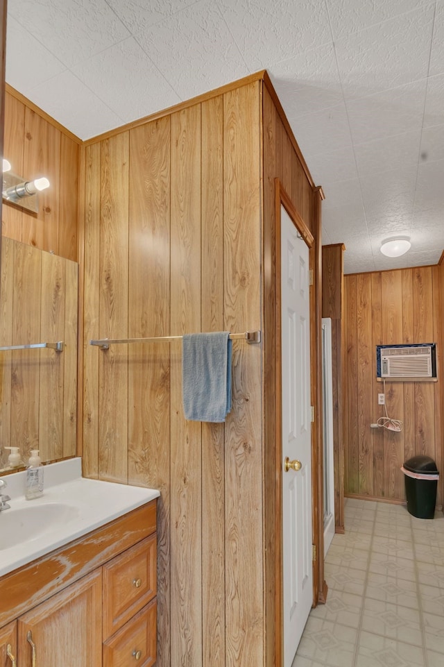 327 Saddle Club Rd, Weatherford, TX 76088 - bathroom with a wall mounted AC, wood walls, vanity, and tile patterned floors
