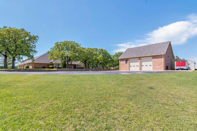 327 Saddle Club Rd, Weatherford, TX 76088 - view of front of property with a detached garage, a front lawn, driveway, an outbuilding, and brick siding