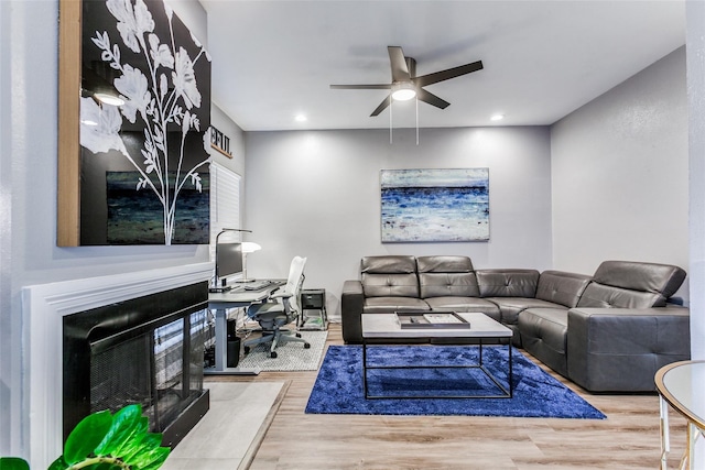 living room featuring wood finished floors, a fireplace, recessed lighting, and ceiling fan