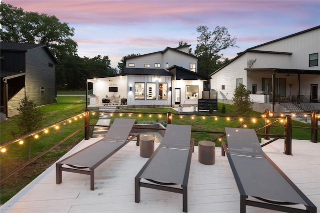 back of house with a yard and a wooden deck